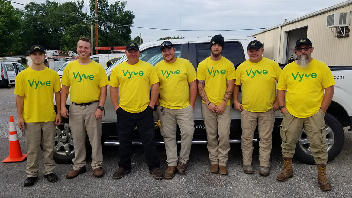 Vyve employees pose with their Vyve Green shirts