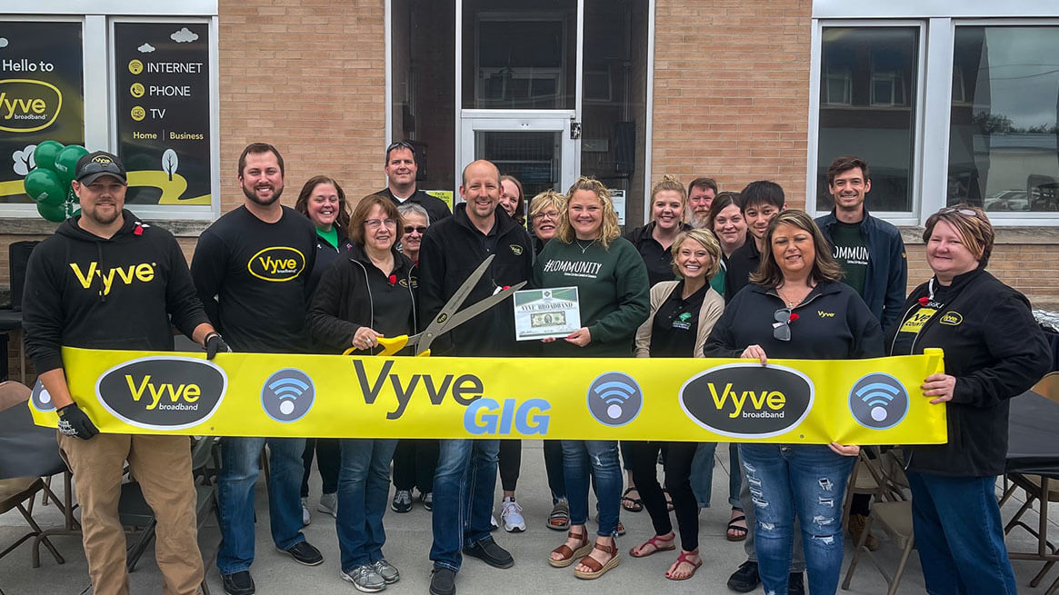 Vyve team members posing with yellow Vyve Gig banner